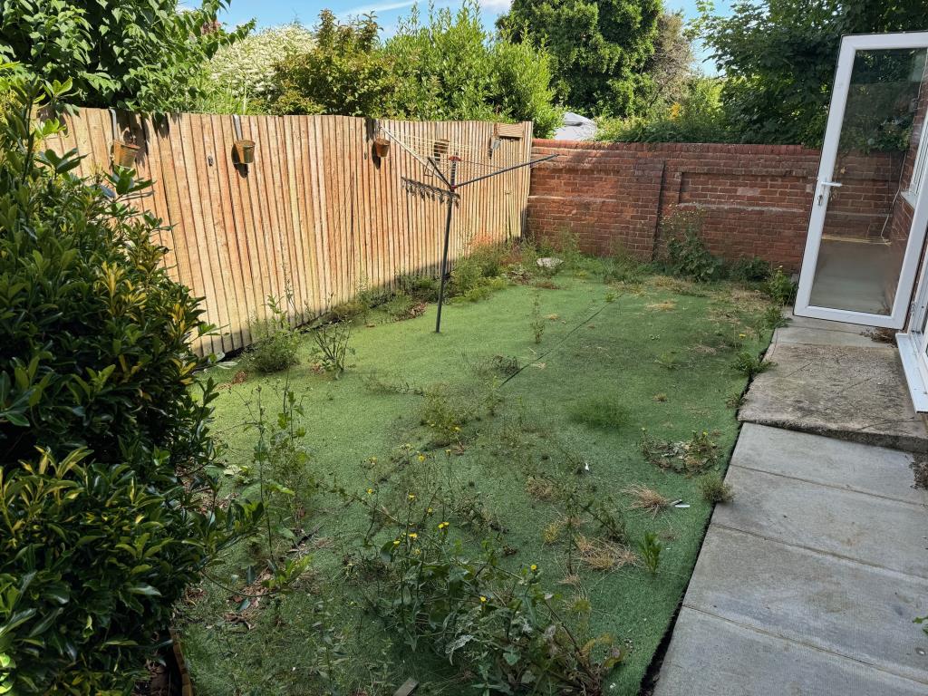 Lot: 74 - HEAD LEASEHOLD INVESTMENT - BLOCK OF FIVE FLATS, THREE-BEDROOM COTTAGE AND THREE GARAGES - The Cottage - rear garden